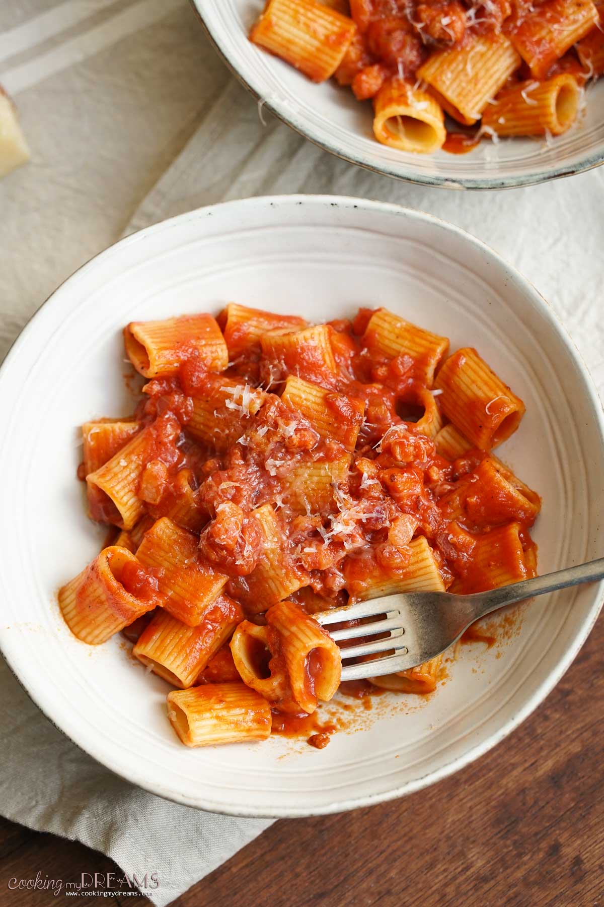 fork taking a bite of rigatoni amatriciana.