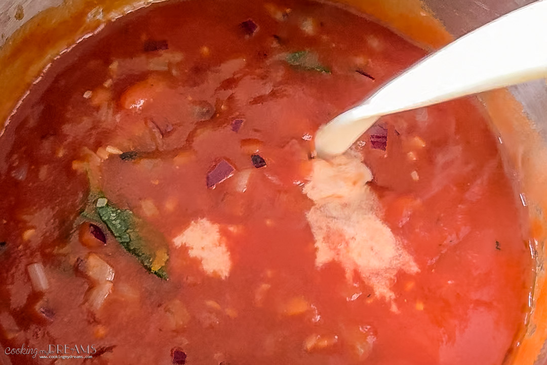 cream pouring in the tomato soup.