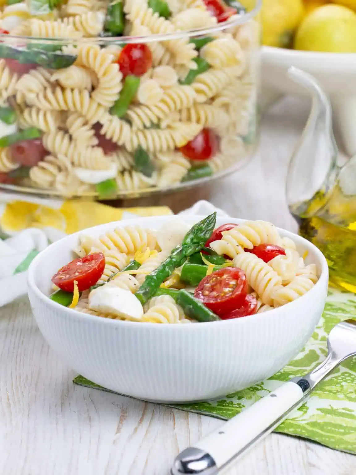 bowl with spring pasta salad with asparagus and tomatoes.