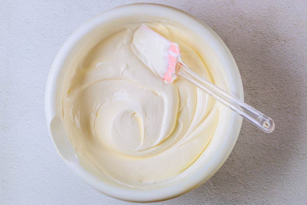 spatula folding in the cream in a bowl.