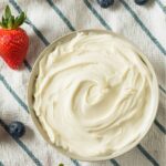 mascarpone cream in a bowl surrounded by berries.