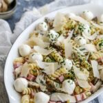 oval platter with marinated artichokes pasta salad.