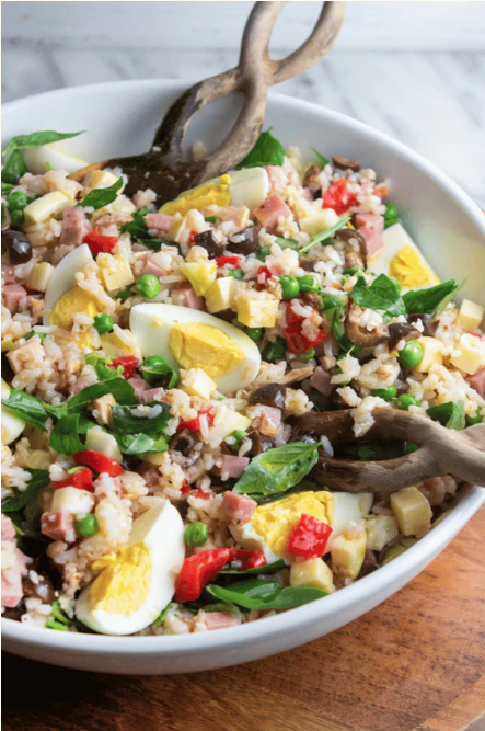 rice salad in a bowl with a spoon.