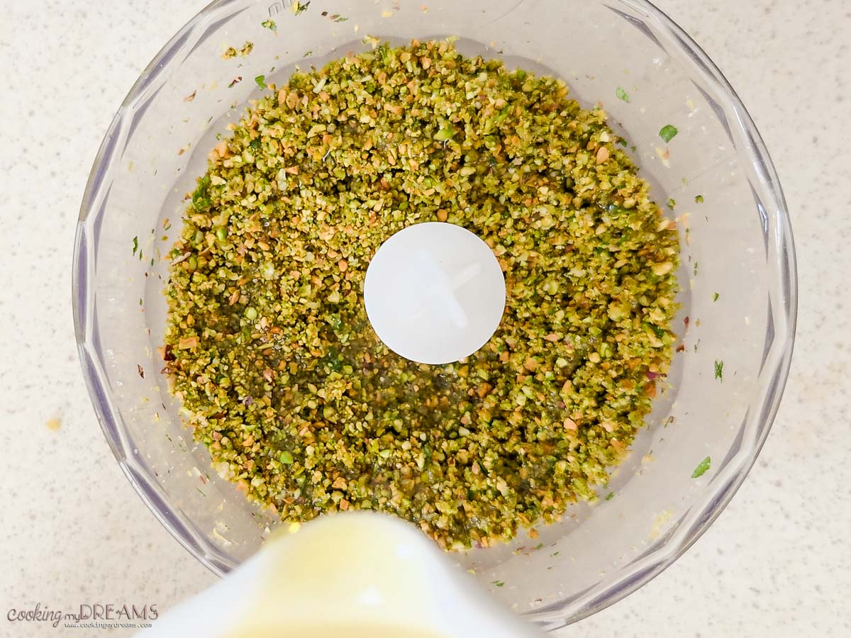 pistachios finely minced in a food processor while oil is added.