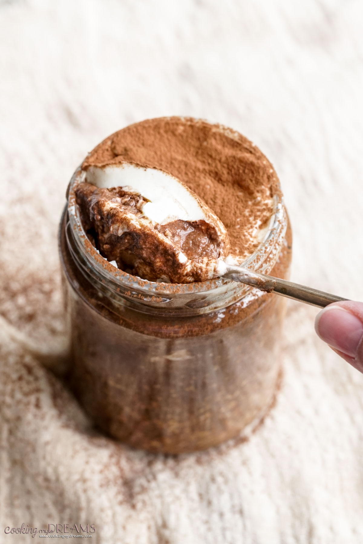 spoon lifting a bite of tiramisu overnight oats.
