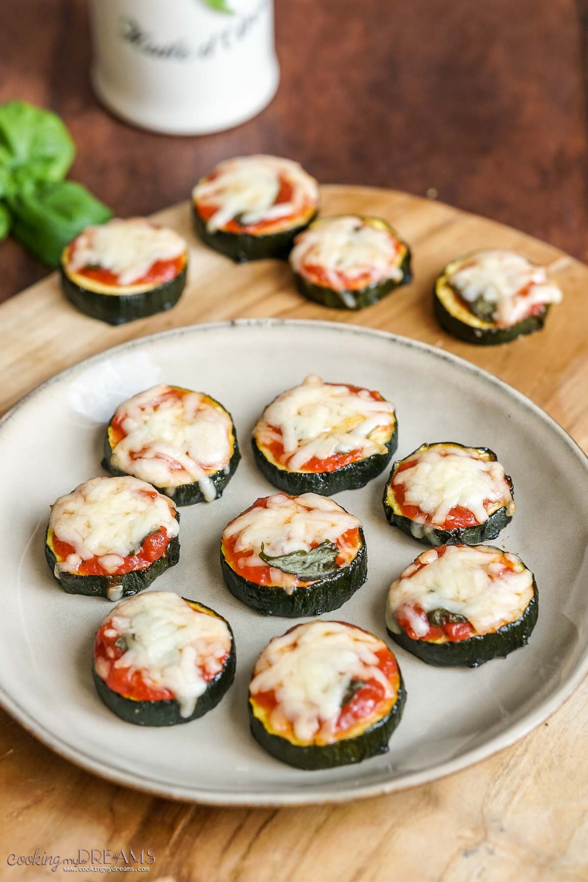zucchini pizza bites on wooden board.