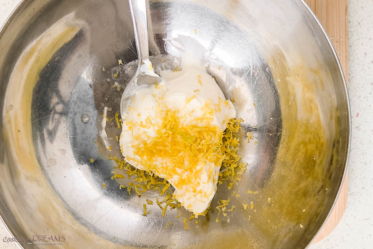 spoon mixing cream cheese and lemon zest.