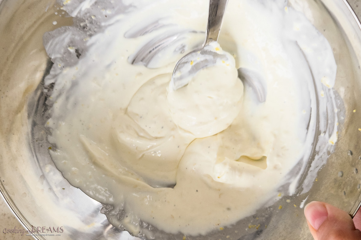 spoon making the creamy lemon sauce.
