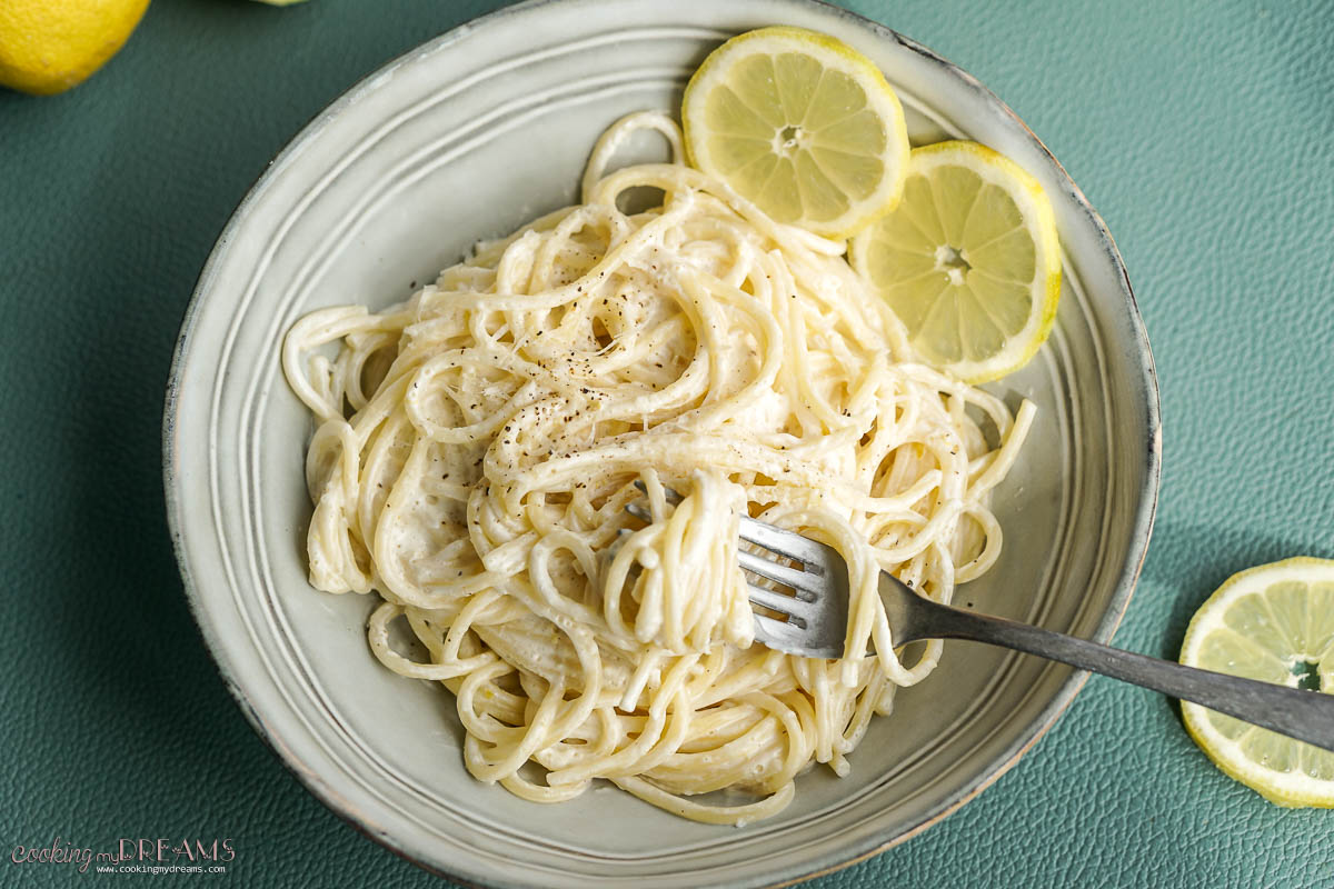 fork twirling lemon spaghetti in a bowl.